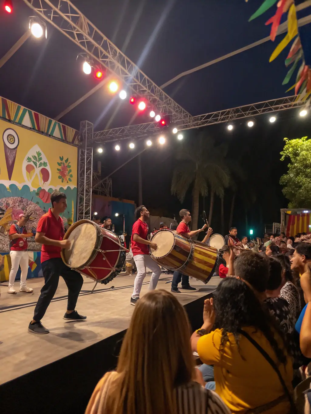 A vibrant street performance featuring drummers in colorful costumes, showcasing the energy and excitement of LES PERCUS DU DIABLE LES PDD's musical projects.